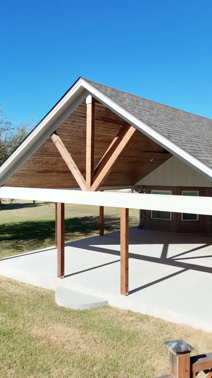 Finished gable patio cover with a cedar king post truss over a new slab