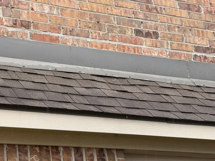 New counter flashing where shingle roof meets brick wall