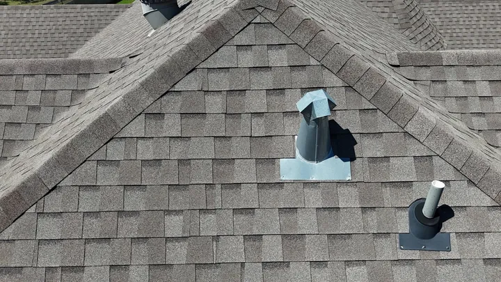 Ridge, new roof vents and a pipe boot on fresh shingles