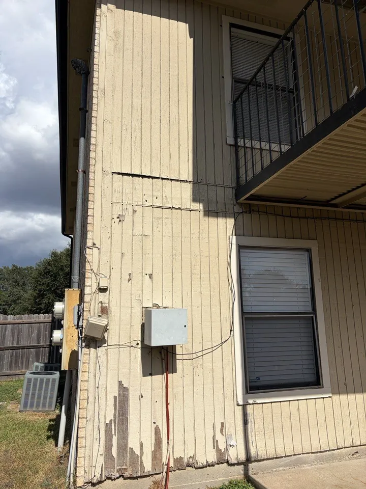 Before the work: rotted, delaminating siding at an outside corner